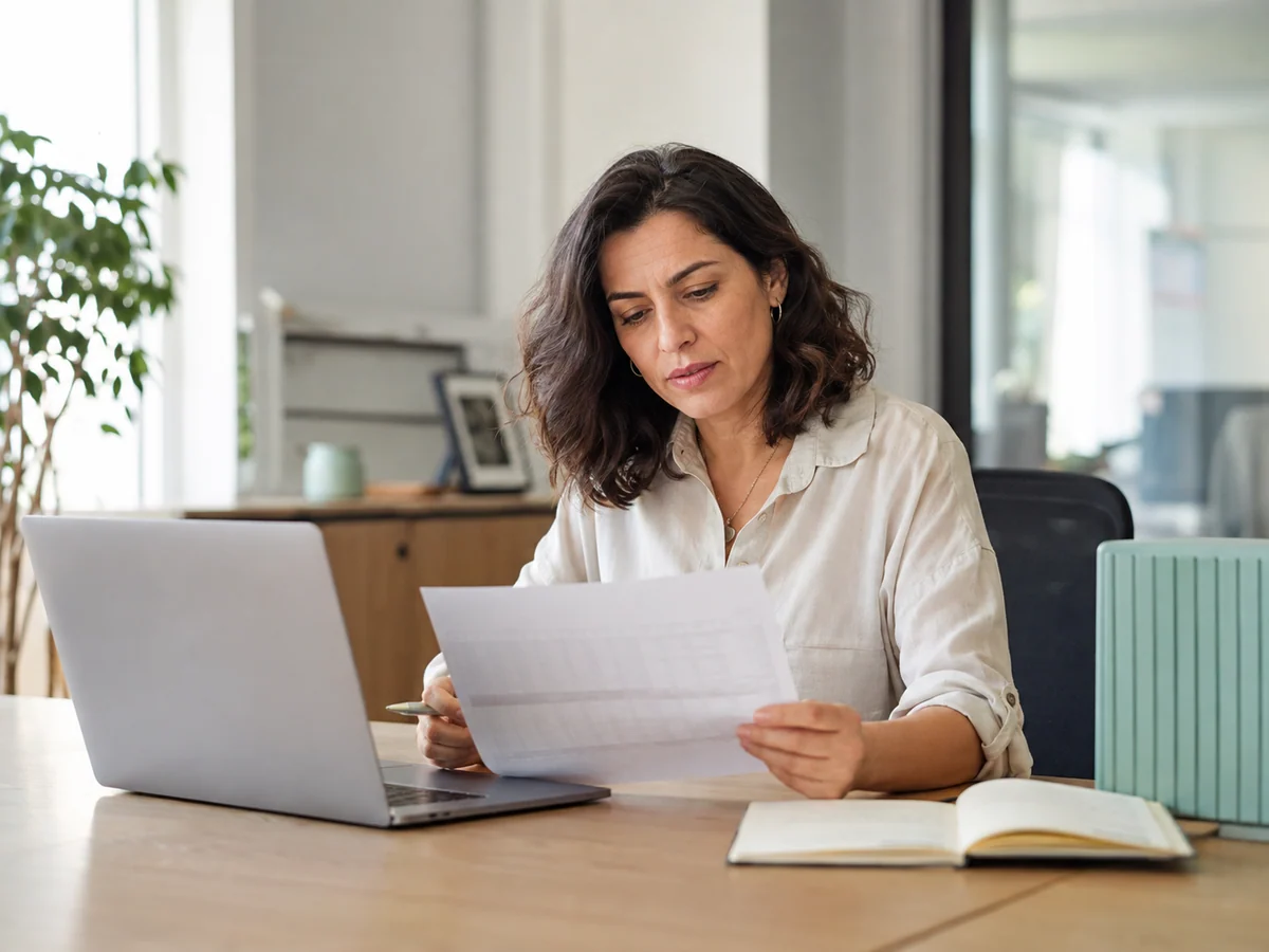 Illustrative image of a professional working on procurement in a bright office.